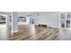 Spacious living room with modern floors, a decorative wall, and sliding doors at 855 Bayway Blvd # 105, Clearwater, FL 33767