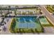 Aerial shot of tennis courts and a bocce court surrounded by mature landscaping at 855 Bayway Blvd # 105, Clearwater, FL 33767