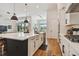 Bright kitchen with stainless steel appliances, an island with bar seating, and pendant lighting at 978 Signet Dr, Apollo Beach, FL 33572