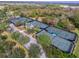 Aerial view of the community tennis courts, surrounded by trees and landscaping at 978 Signet Dr, Apollo Beach, FL 33572