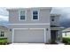 Charming two-story home featuring a large garage, neutral paint, and well-maintained landscaping at 10741 Hidden Banks Gln, Parrish, FL 34219