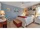 Well-lit bedroom featuring beach-themed decor, a ceiling fan, and a comfortable queen-sized bed at 127 Jennifer Dr, Rotonda West, FL 33947