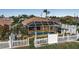 Aerial view of private pool, screened enclosure, tropical landscaping, and white picket fence at 127 Jennifer Dr, Rotonda West, FL 33947