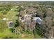 Aerial showcasing several homes and lake in a wooded neighborhood at 1301 Jen Ma Jo Ln, Lutz, FL 33549