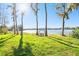 Beautiful lakefront property with grassy lawn, mature trees and inviting swing at 1301 Jen Ma Jo Ln, Lutz, FL 33549