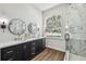 Modern bathroom featuring double vanity sinks and a luxurious glass-enclosed shower at 1301 Jen Ma Jo Ln, Lutz, FL 33549