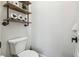 Charming half bathroom features floating shelves with sheep decor and an industrial pipe design at 1301 Jen Ma Jo Ln, Lutz, FL 33549