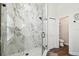 Modern bathroom featuring a glass enclosed shower with marble tile and hexagon mosaic flooring at 1301 Jen Ma Jo Ln, Lutz, FL 33549