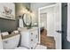 Modern bathroom showcasing vanity sink with a marble counter, wall decor, and a toilet at 1301 Jen Ma Jo Ln, Lutz, FL 33549