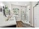 Stylish bathroom featuring double sinks, a walk-in shower with marble tile, and modern fixtures at 1301 Jen Ma Jo Ln, Lutz, FL 33549