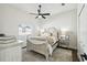 Bright bedroom with a ceiling fan, neutral tones, and a cozy, comfortable bed setup at 1301 Jen Ma Jo Ln, Lutz, FL 33549