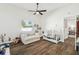 Bright Bedroom with wood floor features a comfy chair, crib, and window views at 1301 Jen Ma Jo Ln, Lutz, FL 33549