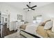 Cozy bedroom features a ceiling fan, window view, neutral decor, and a comfy bed at 1301 Jen Ma Jo Ln, Lutz, FL 33549