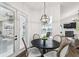 Bright breakfast nook features a modern chandelier, a rustic wood table, and views of the pool at 1301 Jen Ma Jo Ln, Lutz, FL 33549
