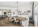 Open-concept dining room with a farmhouse table, decorative shelves, and seamless flow to the kitchen at 1301 Jen Ma Jo Ln, Lutz, FL 33549