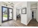 Welcoming entryway featuring dark double doors, sidelights, and a glimpse into a bright home office at 1301 Jen Ma Jo Ln, Lutz, FL 33549