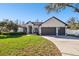 Charming single-story home with a manicured lawn, two-car garage, and a welcoming facade at 1301 Jen Ma Jo Ln, Lutz, FL 33549
