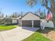 Well-maintained home with a spacious driveway, two-car garage, and a neatly manicured lawn at 1301 Jen Ma Jo Ln, Lutz, FL 33549