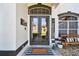 Stylish entryway featuring double doors, a welcome mat, and a cozy bench for a warm, inviting feel at 1301 Jen Ma Jo Ln, Lutz, FL 33549