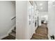 Hallway view of the kitchen featuring ample cabinet space and stairs to the second floor at 1301 Jen Ma Jo Ln, Lutz, FL 33549