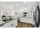 Bright kitchen with an island cooktop, stainless steel appliances, and an open view of the living area at 1301 Jen Ma Jo Ln, Lutz, FL 33549