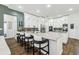 Spacious kitchen with white cabinets, a marble countertop island with seating, and modern appliances at 1301 Jen Ma Jo Ln, Lutz, FL 33549