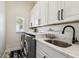 Clean laundry room with modern appliances, ample counter space, and stylish decor at 1301 Jen Ma Jo Ln, Lutz, FL 33549
