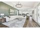Open-concept living room leading to the kitchen boasts modern lighting and stylish decor at 1301 Jen Ma Jo Ln, Lutz, FL 33549