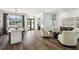 Open layout showcasing hardwood floors, living room, and dining area with natural light at 1301 Jen Ma Jo Ln, Lutz, FL 33549