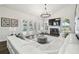 Bright living room boasts a white fireplace, lake views from arched windows, and a comfortable sectional sofa at 1301 Jen Ma Jo Ln, Lutz, FL 33549