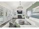Bright living room with a fireplace, a modern chandelier, and a view of the pool at 1301 Jen Ma Jo Ln, Lutz, FL 33549