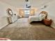 Comfortable main bedroom featuring a ceiling fan, area rug, and a cozy seating area with natural light at 1301 Jen Ma Jo Ln, Lutz, FL 33549