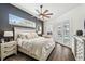 Cozy main bedroom features a ceiling fan, French doors to the pool, and stylish decor at 1301 Jen Ma Jo Ln, Lutz, FL 33549