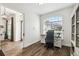 Well-lit office featuring a large window, a stylish desk, and wood flooring for a comfortable workspace at 1301 Jen Ma Jo Ln, Lutz, FL 33549