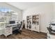 Bright home office with large arched window, hardwood floors, and a built-in bookcase at 1301 Jen Ma Jo Ln, Lutz, FL 33549