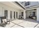 Covered patio with comfortable seating, providing a relaxing outdoor living space near the pool area at 1301 Jen Ma Jo Ln, Lutz, FL 33549