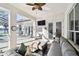 Covered patio with comfortable seating, ceiling fan, and outdoor television for relaxing and entertaining guests at 1301 Jen Ma Jo Ln, Lutz, FL 33549