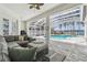 Outdoor screened-in pool area with comfortable seating, offering a relaxing waterfront view at 1301 Jen Ma Jo Ln, Lutz, FL 33549