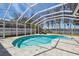 Screened-in pool with brick pavers, providing a relaxing outdoor space with beautiful lake views at 1301 Jen Ma Jo Ln, Lutz, FL 33549