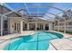 Screened-in pool with pavers, ideal for outdoor relaxation and entertainment with access to the patio area at 1301 Jen Ma Jo Ln, Lutz, FL 33549