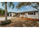 Charming single-story home with stone accents, a well-manicured lawn, and a cozy front porch at 1306 Coppertree Dr, Tarpon Springs, FL 34689