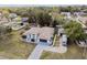 Attractive single-story home with a screened-in pool area, complemented by mature trees and lush landscaping at 13635 Coronado Dr, Spring Hill, FL 34609