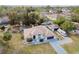 Aerial view of house with screened pool, two car garage, long driveway and RV parking at 13635 Coronado Dr, Spring Hill, FL 34609