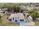 Charming single-story home featuring an RV parking spot and screened-in pool, nestled amongst mature trees at 13635 Coronado Dr, Spring Hill, FL 34609