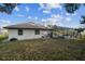 A yard with a house and a screened pool with lots of green space at 13635 Coronado Dr, Spring Hill, FL 34609