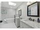 Bathroom featuring double vanity sinks, a soaking tub and bright natural light at 13635 Coronado Dr, Spring Hill, FL 34609