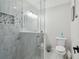 Bathroom featuring a glass shower with stylish tile, a toilet, and vanity with marble countertop at 13635 Coronado Dr, Spring Hill, FL 34609