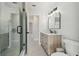 Bathroom featuring a vanity with marble countertop, glass enclosed shower, and stylish black hardware at 13635 Coronado Dr, Spring Hill, FL 34609