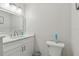 Bathroom featuring a stylish vanity with marble countertop, a toilet, and a mirror with modern lighting at 13635 Coronado Dr, Spring Hill, FL 34609