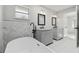Bathroom featuring double vanity sinks and a soaking tub, enhanced by a window with stained glass details at 13635 Coronado Dr, Spring Hill, FL 34609